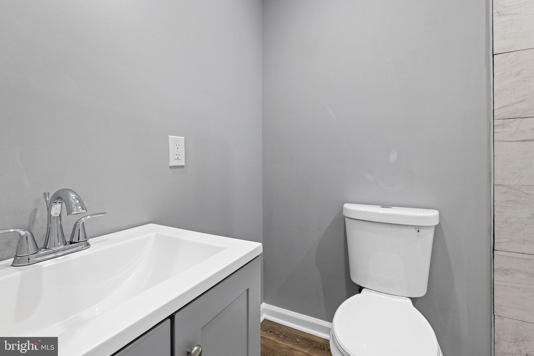 1809 West Lombard Street Baltimore, MD 21223 - Photo 18 of 36 a bathroom with a toilet sink and mirror