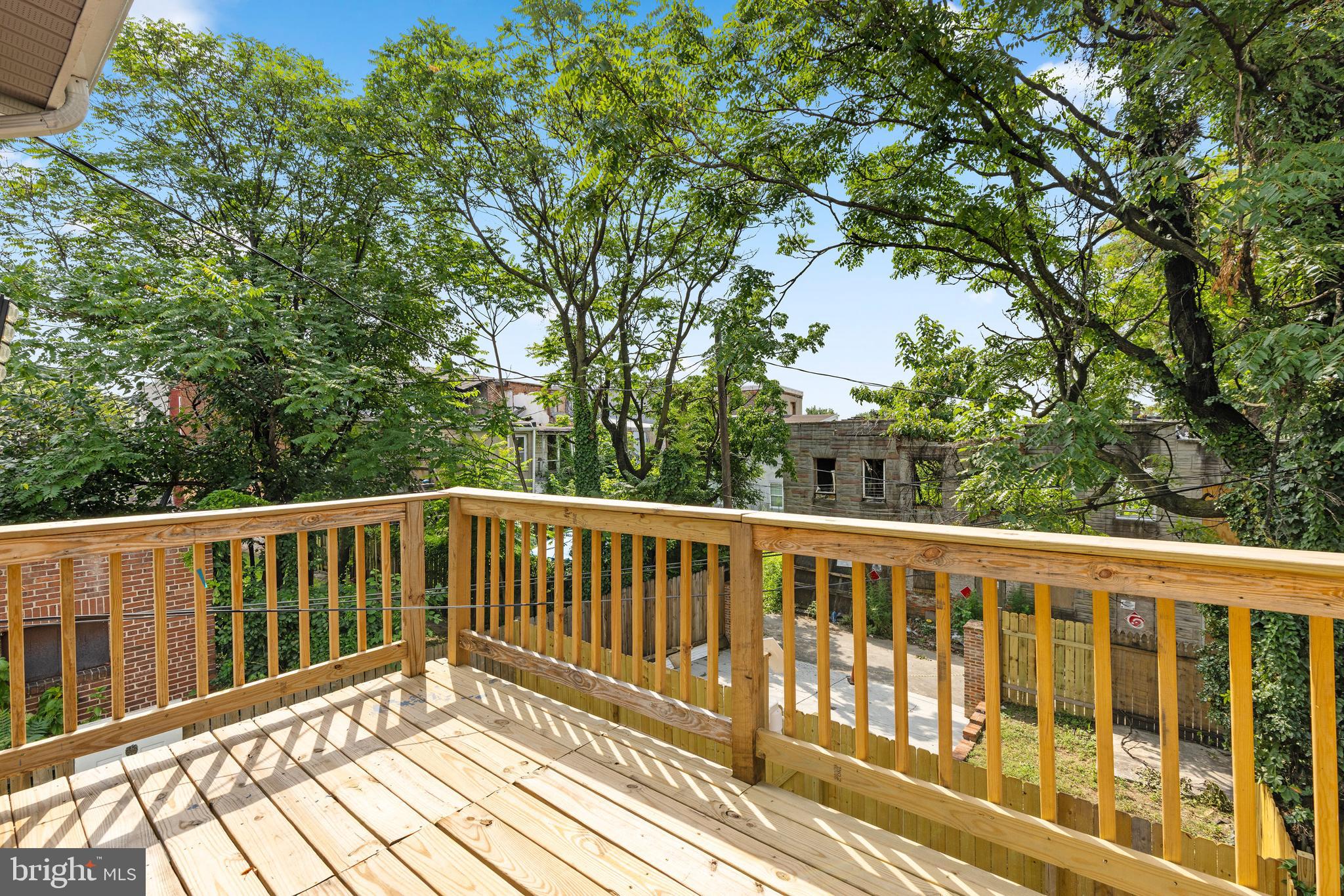 1809 West Lombard Street Baltimore, MD 21223 - Photo 21 of 36 a balcony with wooden floor and fence