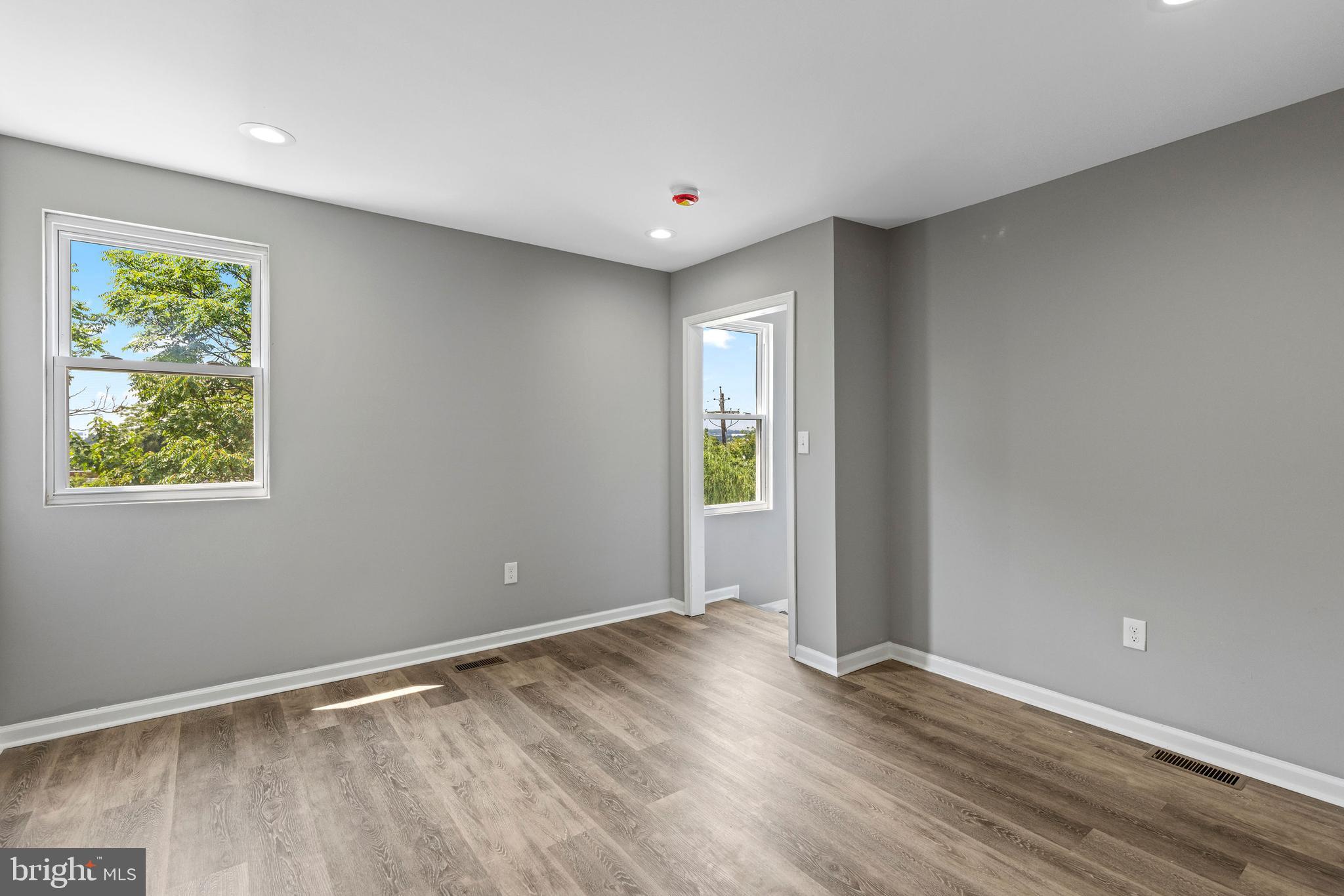1809 West Lombard Street Baltimore, MD 21223 - Photo 26 of 36 wooden floor in an empty room with a window