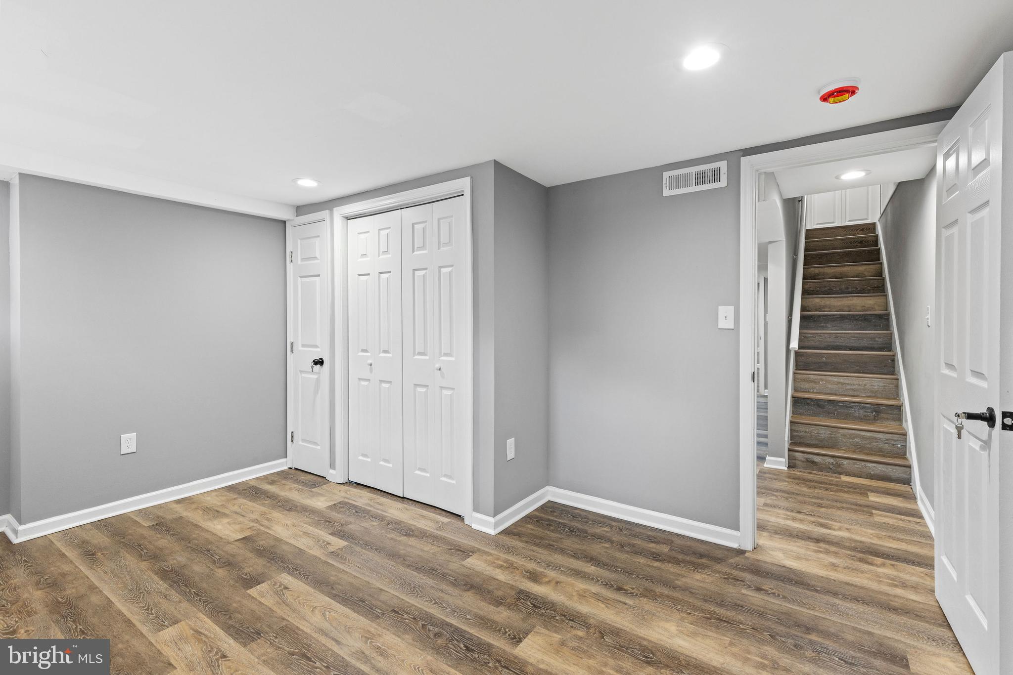 1809 West Lombard Street Baltimore, MD 21223 - Photo 28 of 36 a view of an empty room with wooden floor