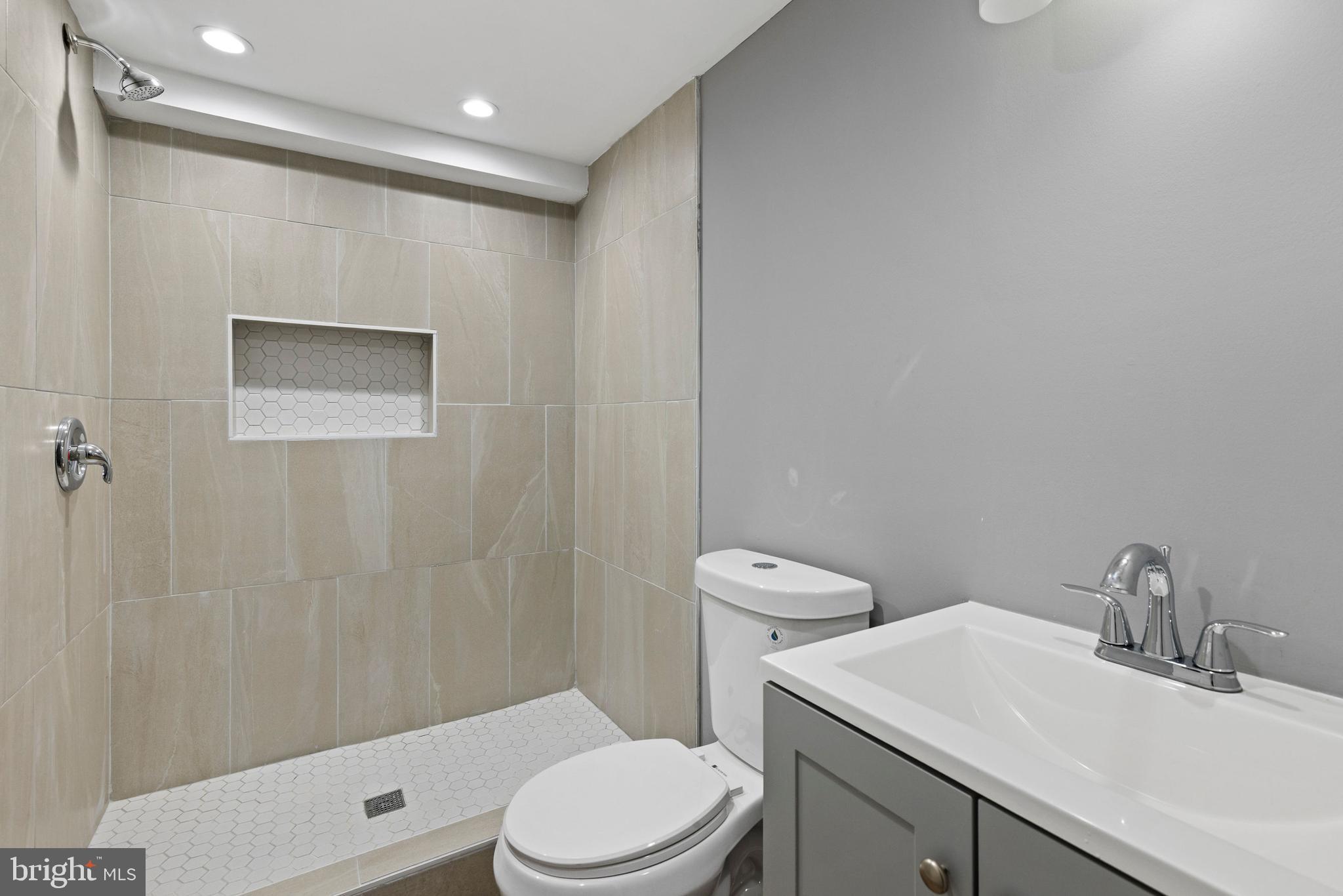 1809 West Lombard Street Baltimore, MD 21223 - Photo 32 of 36 a bathroom with a sink a toilet and shower