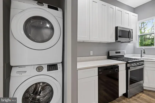 a kitchen with a stove and a washer dryer