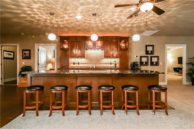415 Ridgecrest Lane Lebanon, TN 37087 - Photo 16 of 20 Another fantastic entertaining space down stairs featuring an eat-in bar, wine fridge, ice maker, custom bar sink all surrounded by rare Maximus Granite