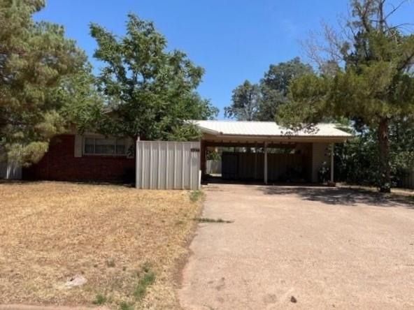 407 Eddy Street Quanah, TX 79252 - Photo 1 of 1 a front view of a house with a yard and garage