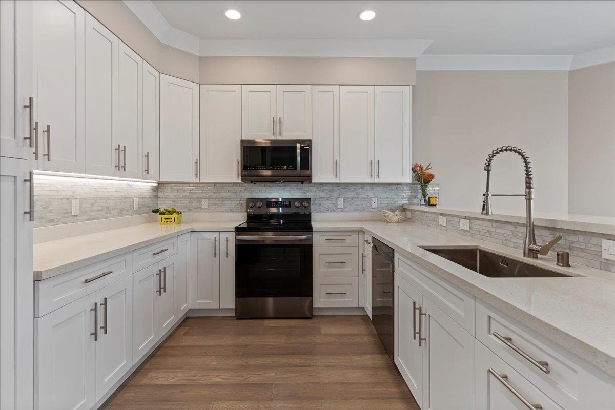 2757 South Kihei Road, Unit 801 Kihei, HI 96753 - Photo 14 of 41 a kitchen with white cabinets and stainless steel appliances