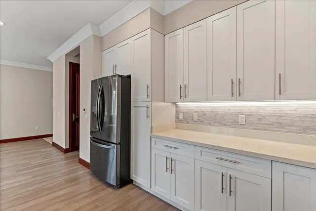 a kitchen with stainless steel appliances granite countertop a refrigerator and a sink