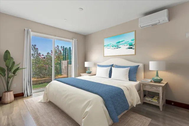 a view of an empty room with kitchen and a window