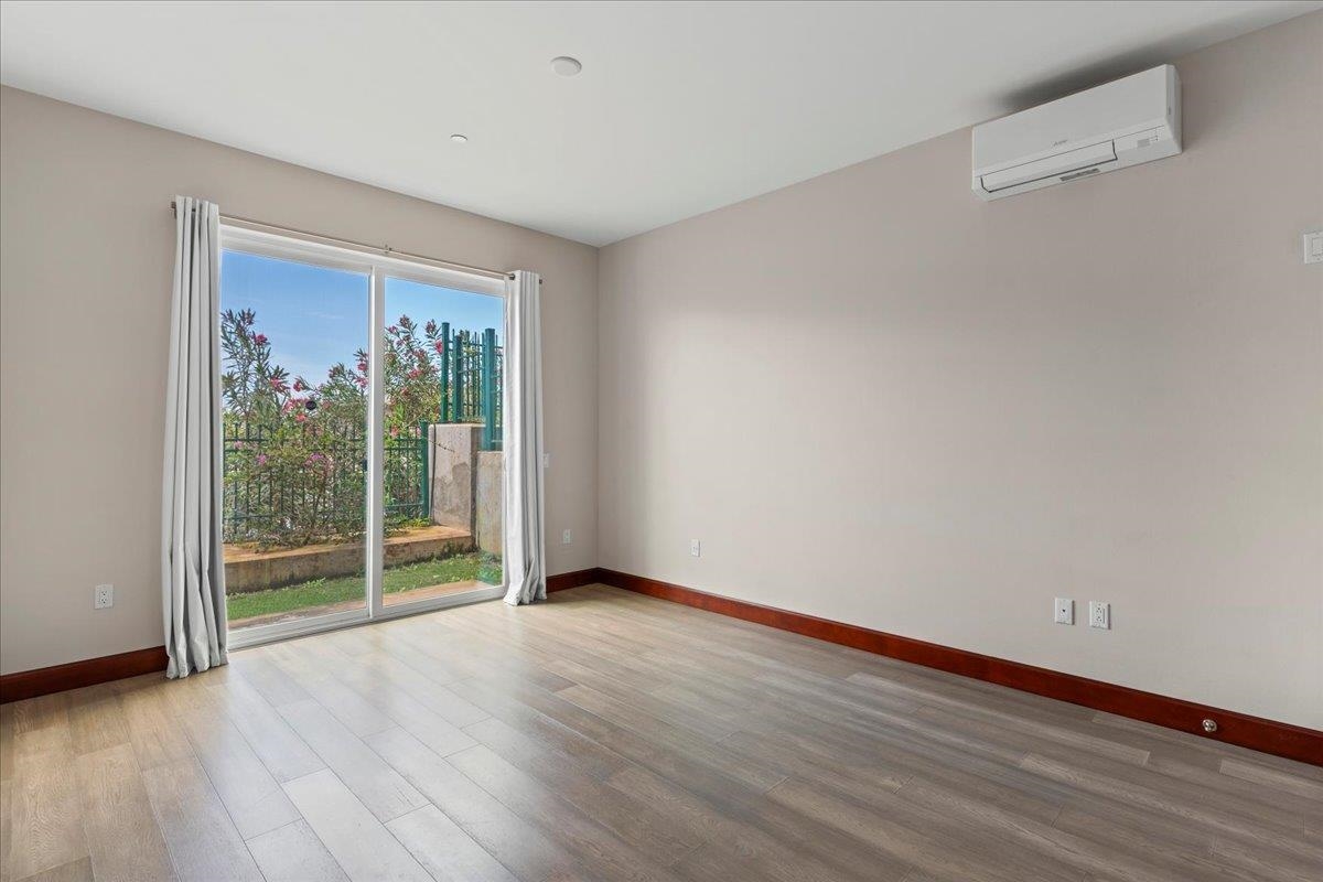 2757 South Kihei Road, Unit 801 Kihei, HI 96753 - Photo 25 of 41 a view of an empty room with wooden floor and a window
