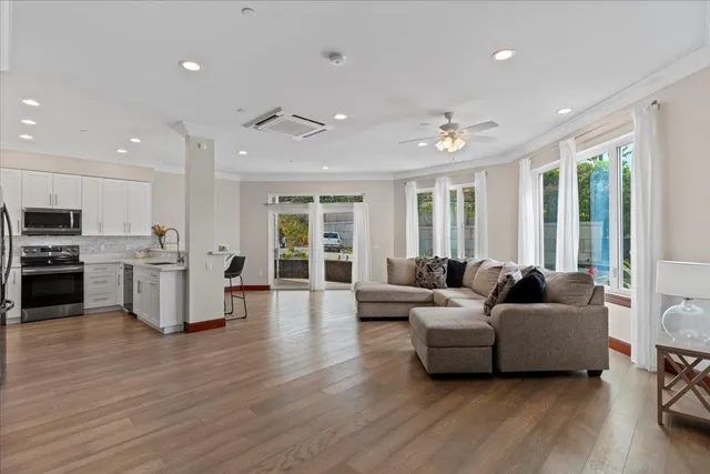 a living room with furniture and wooden floor