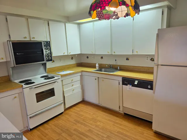 a kitchen with a sink a stove and cabinets