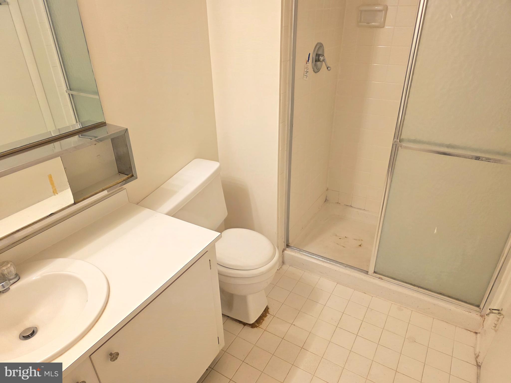 6317 Park Heights Avenue, Unit 103 Baltimore, MD 21215 - Photo 8 of 10 a bathroom with a sink toilet and shower