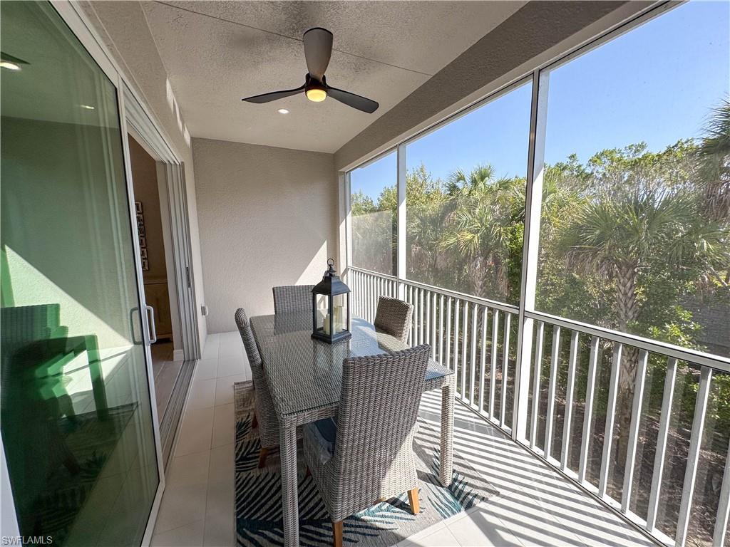 262 Indies Drive East, Unit 201 Naples, FL 34114 - Photo 14 of 45 a view of a balcony dining table and chairs
