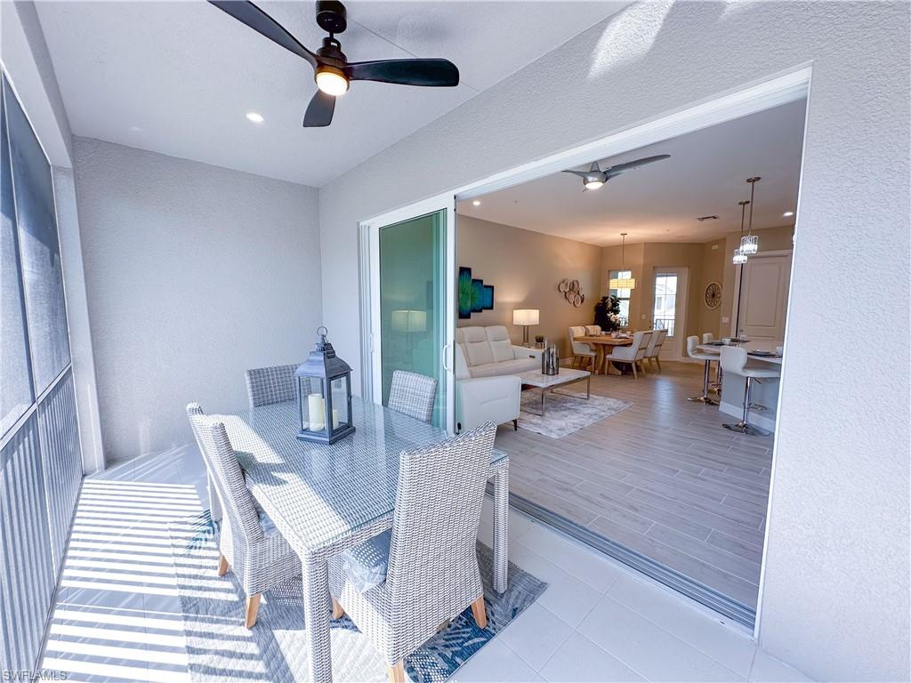 262 Indies Drive East, Unit 201 Naples, FL 34114 - Photo 16 of 45 a view of a dining room and livingroom with furniture wooden floor a chandelier