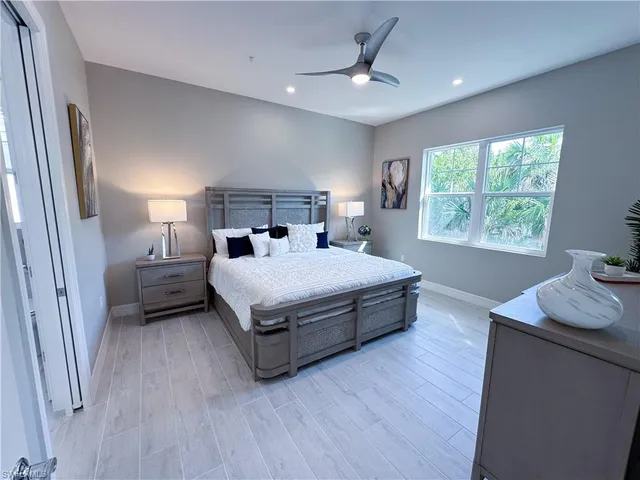 a bedroom with a bed a couch and a window