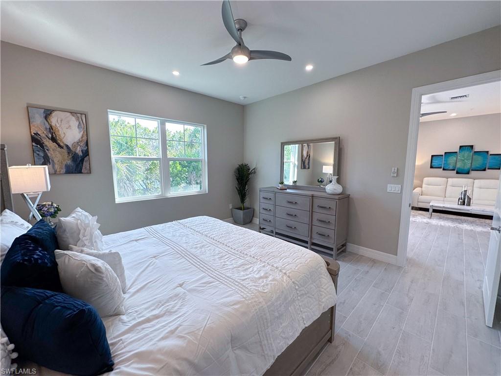 262 Indies Drive East, Unit 201 Naples, FL 34114 - Photo 20 of 45 a bed room with a bed and a television
