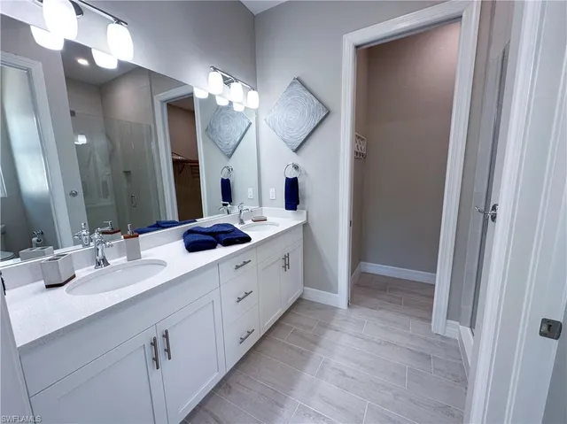 a bathroom with a double vanity sink and a mirror