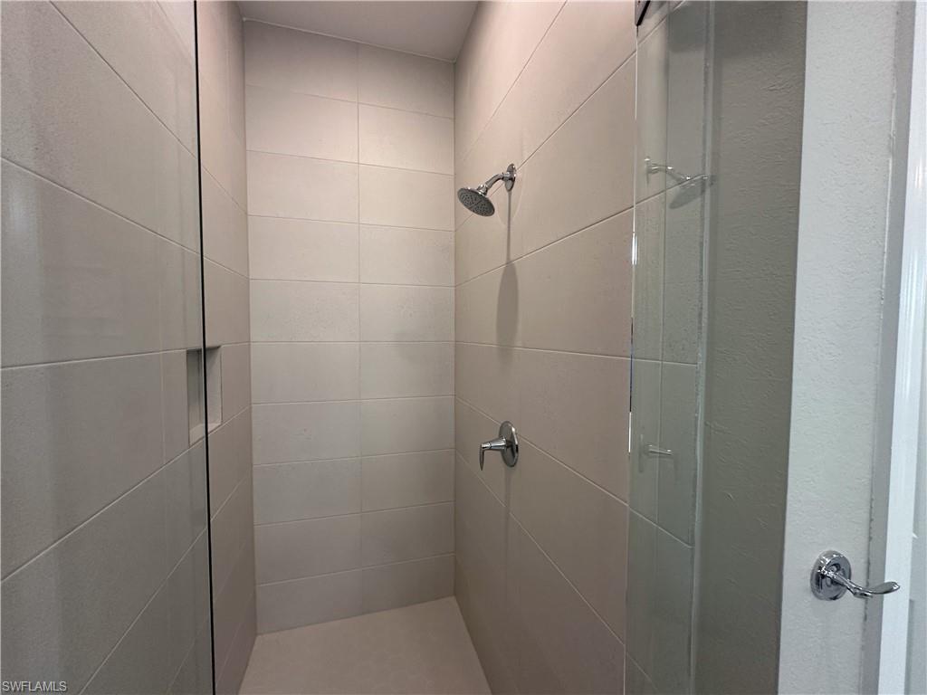 262 Indies Drive East, Unit 201 Naples, FL 34114 - Photo 23 of 45 a bathroom with a shower