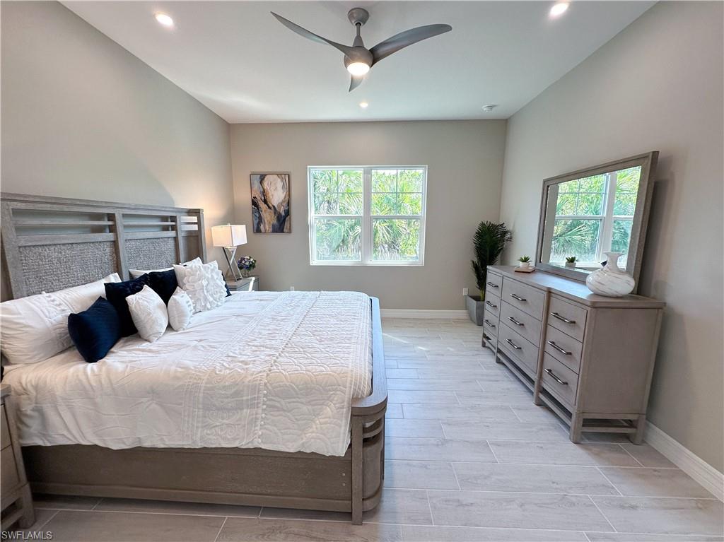 262 Indies Drive East, Unit 201 Naples, FL 34114 - Photo 24 of 45 a bedroom with a bed and a window