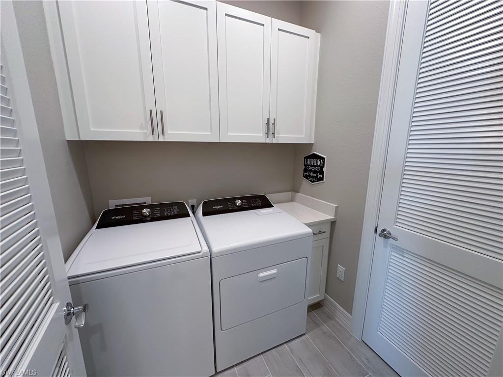 262 Indies Drive East, Unit 201 Naples, FL 34114 - Photo 25 of 45 a utility room with dryer and washer