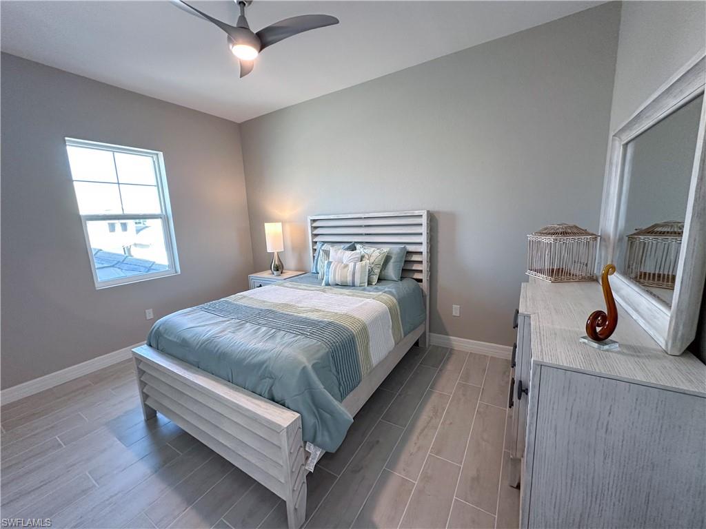 262 Indies Drive East, Unit 201 Naples, FL 34114 - Photo 26 of 45 a bed room with a bed and a window