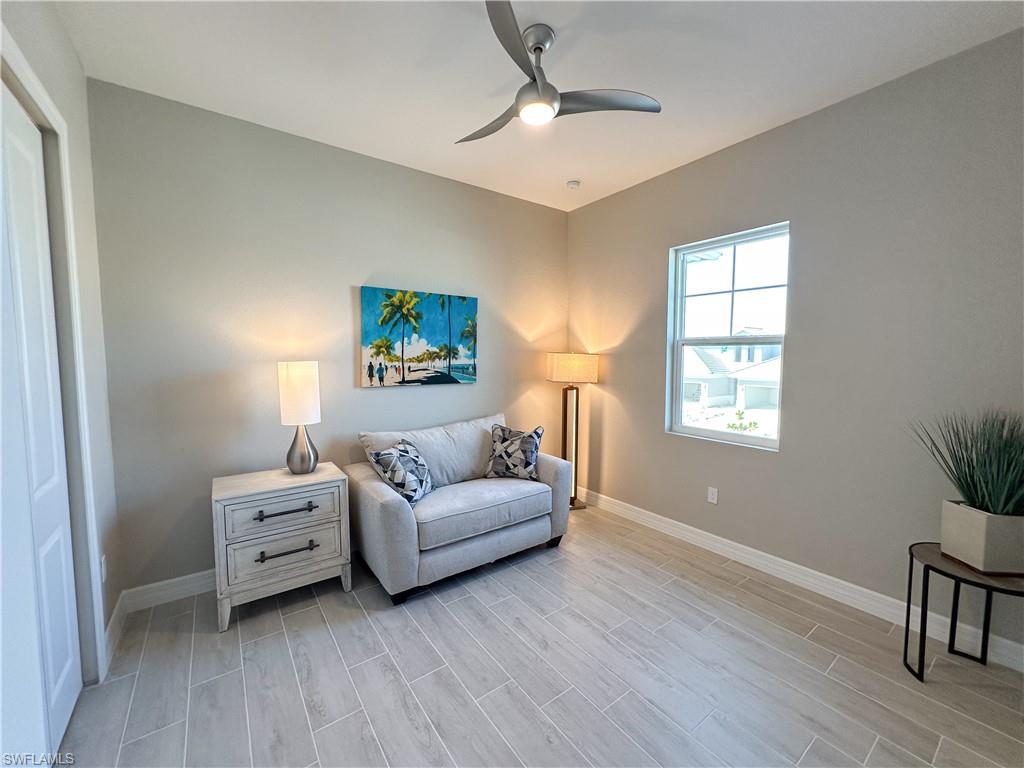 262 Indies Drive East, Unit 201 Naples, FL 34114 - Photo 28 of 45 a living room with furniture and a window