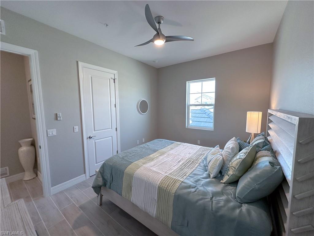 262 Indies Drive East, Unit 201 Naples, FL 34114 - Photo 31 of 45 a bedroom with a bed and a window