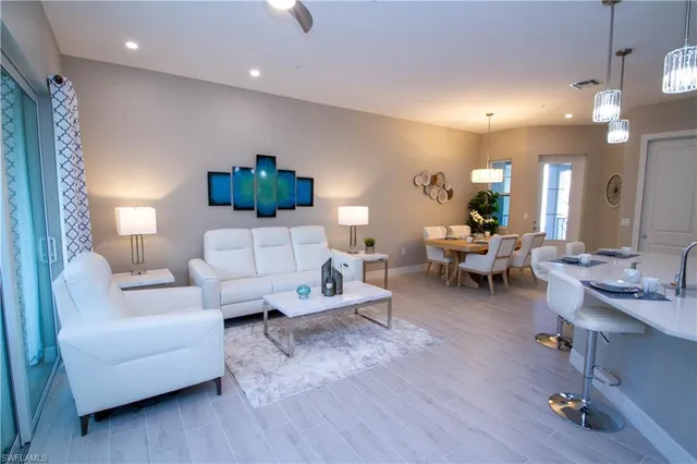 a living room with furniture and a chandelier