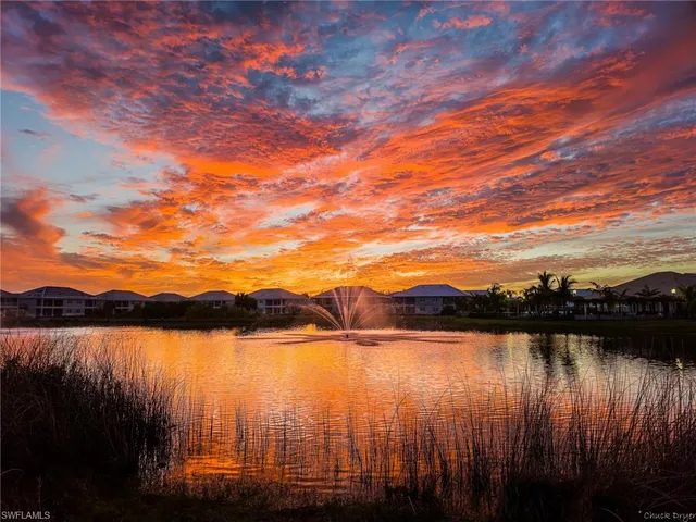 a view of a lake with houses in the back