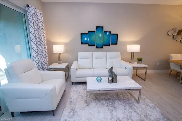 a living room with furniture and a lamp