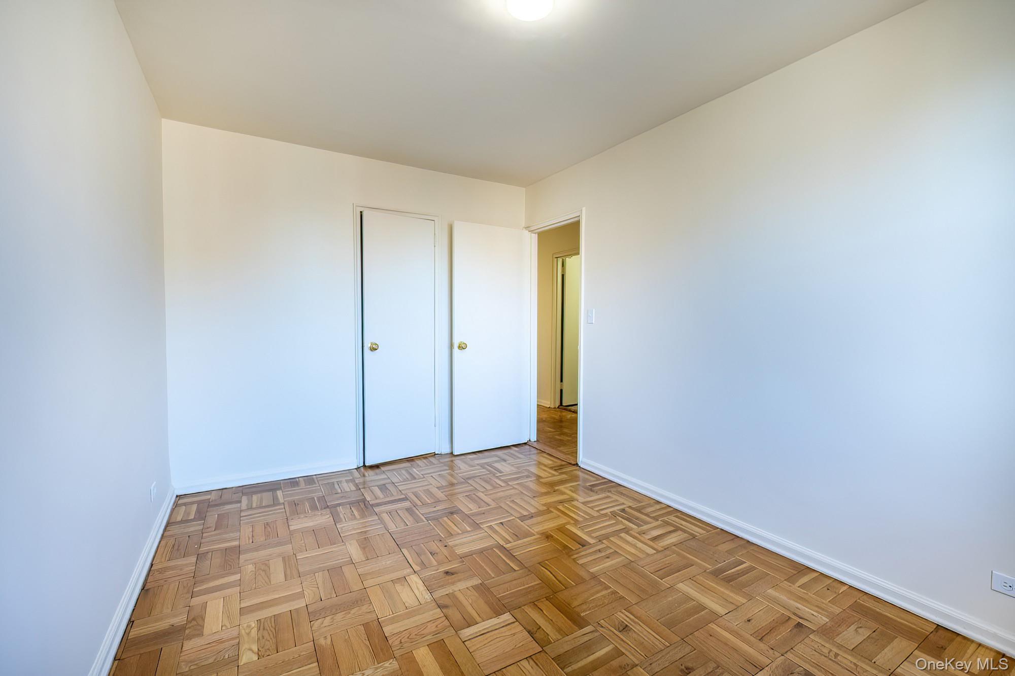 25 Knolls Crescent, Unit 9E Bronx, NY 10463 - Photo 13 of 23 Unfurnished bedroom featuring baseboards and a closet