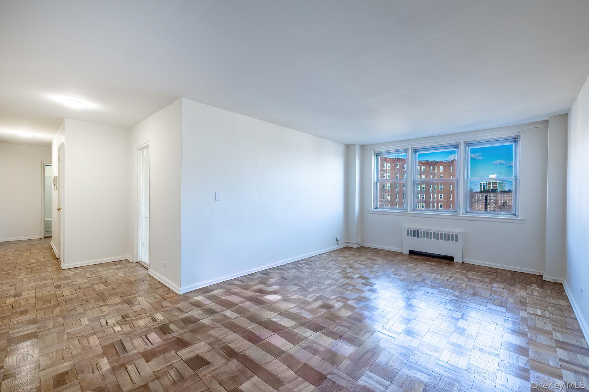 25 Knolls Crescent, Unit 9E Bronx, NY 10463 - Photo 2 of 23 Unfurnished room featuring radiator heating unit and baseboards