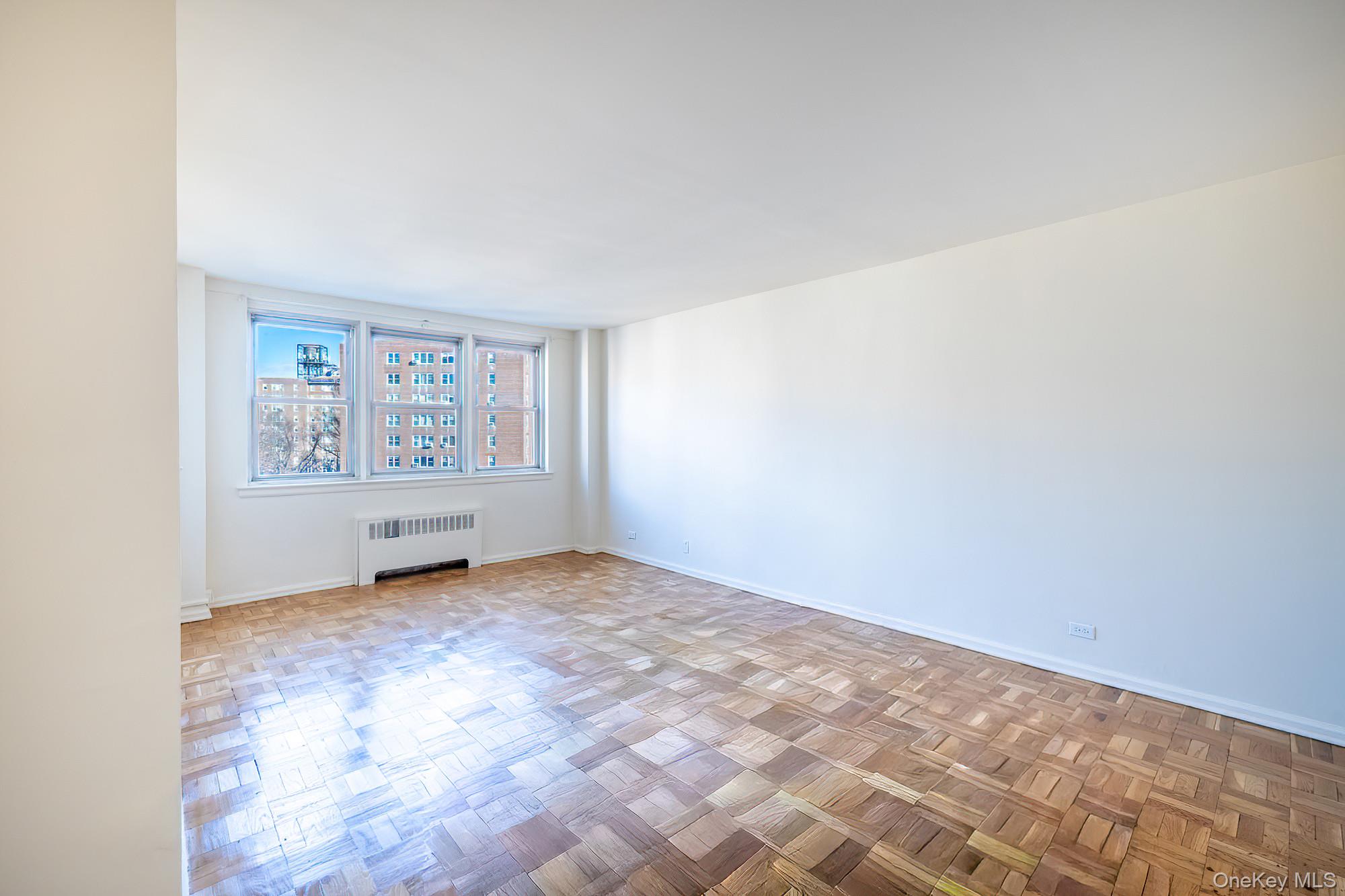 25 Knolls Crescent, Unit 9E Bronx, NY 10463 - Photo 3 of 23 Empty room with radiator and baseboards