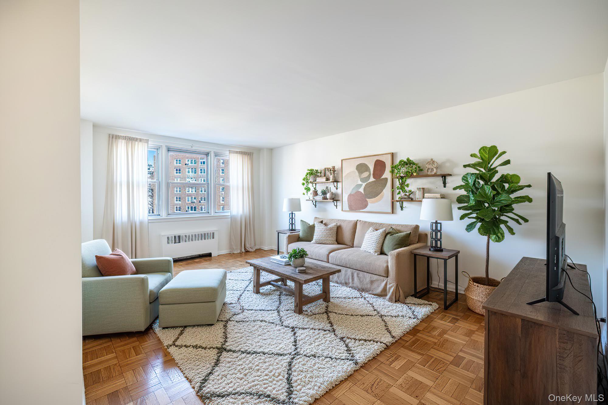 25 Knolls Crescent, Unit 9E Bronx, NY 10463 - Photo 4 of 23 Living area featuring radiator heating unit and baseboards
