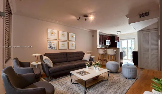 a living room with furniture a rug and a window