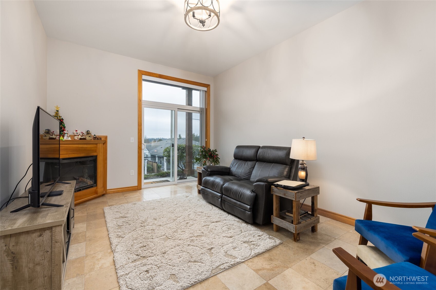 3706 Portage Lane, Unit 102 Anacortes, WA 98221 - Photo 13 of 23 a living room with furniture a piano and a fireplace