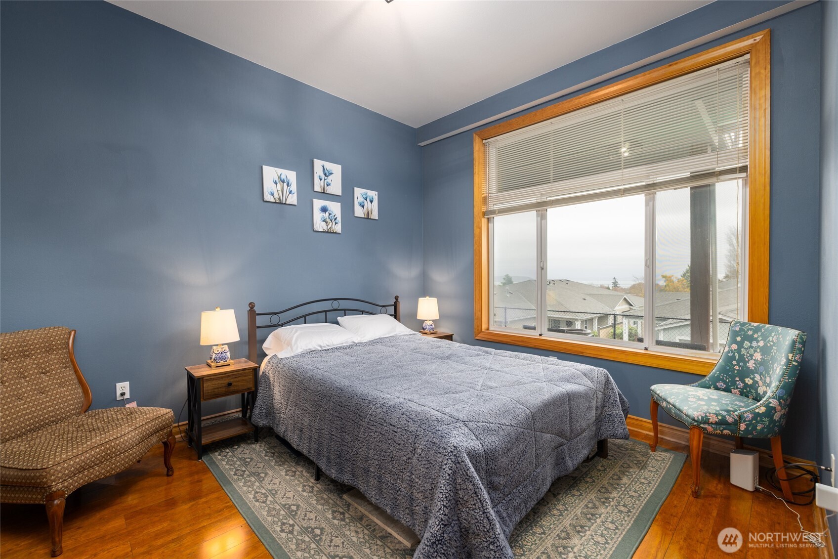 3706 Portage Lane, Unit 102 Anacortes, WA 98221 - Photo 16 of 23 a bedroom with a bed and wooden floor
