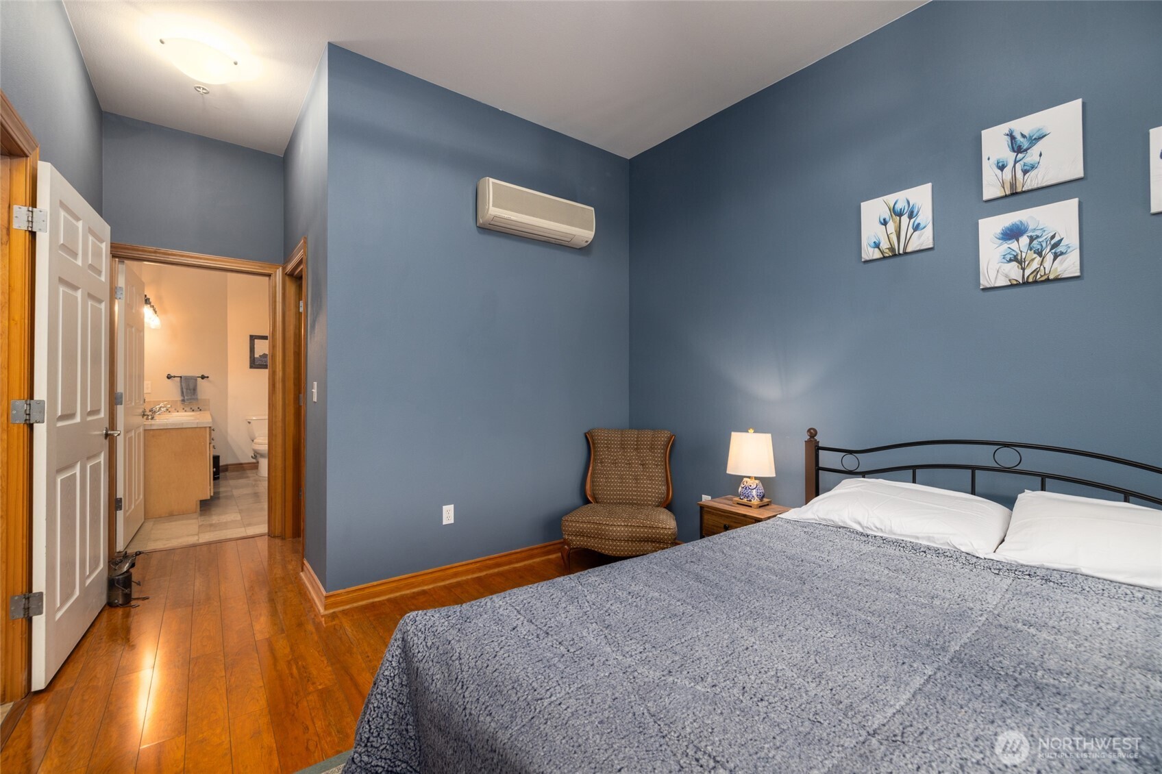 3706 Portage Lane, Unit 102 Anacortes, WA 98221 - Photo 17 of 23 a bedroom with a bed and wooden floor