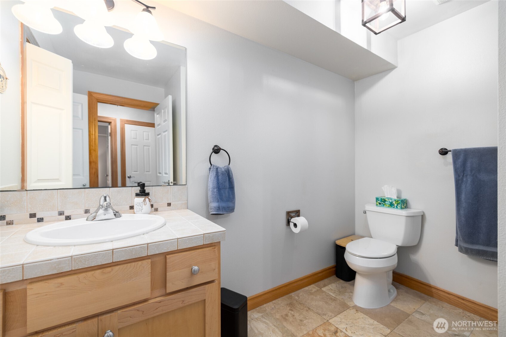 3706 Portage Lane, Unit 102 Anacortes, WA 98221 - Photo 6 of 23 a bathroom with a sink and a mirror