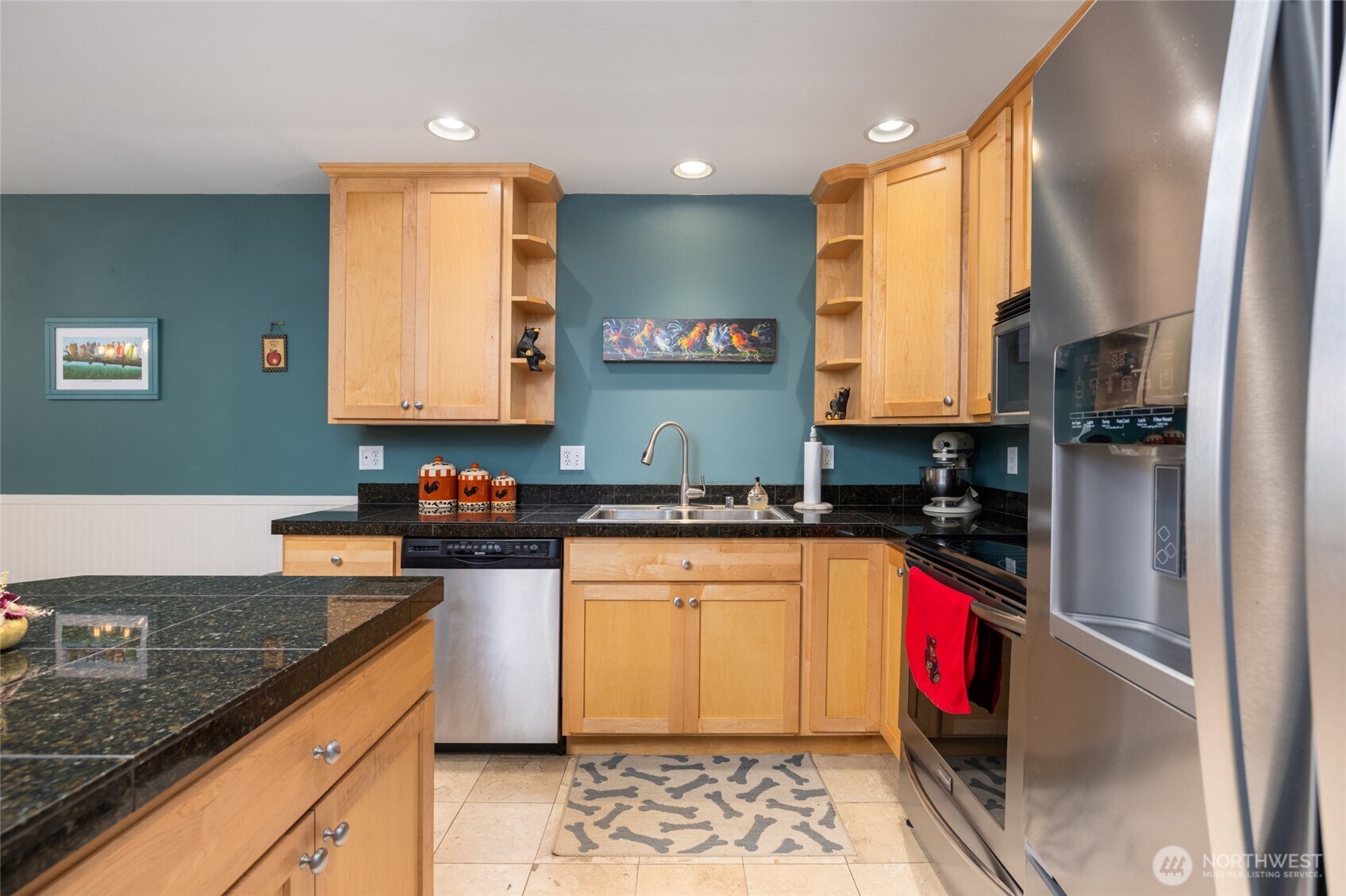3706 Portage Lane, Unit 102 Anacortes, WA 98221 - Photo 9 of 23 a kitchen with stainless steel appliances granite countertop a stove a sink and a microwave