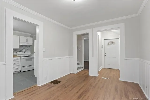 a view of a wooden floor and a kitchen