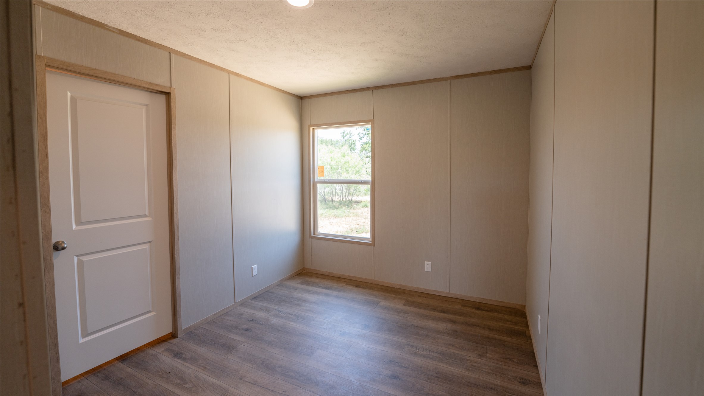 1145 Callihan Road Luling, TX 78648 - Photo 15 of 39 a view of an empty room with wooden floor and a window