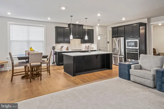 a kitchen with a refrigerator stove and sink