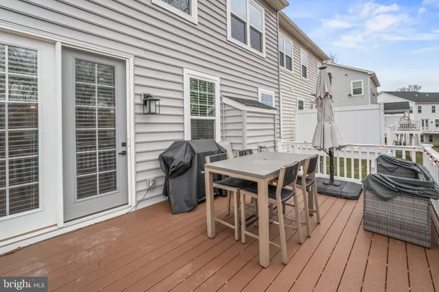 a large kitchen with stainless steel appliances a stove a sink dishwasher and a dining table with the living room view