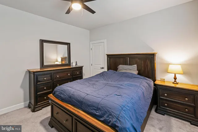 a bathroom with a double vanity sink toilet and a mirror