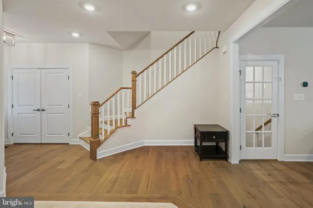 a view of kitchen with stainless steel appliances granite countertop a table and chairs
