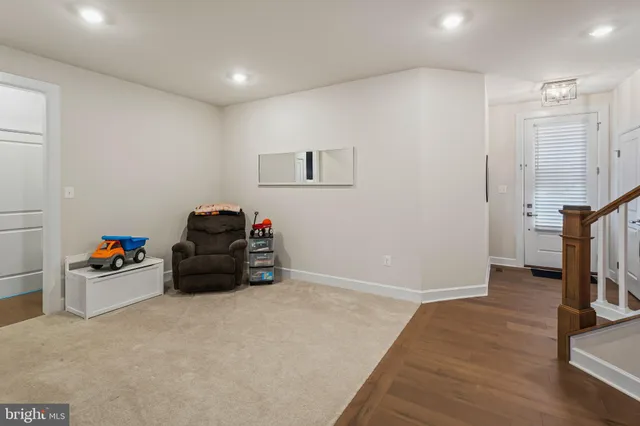a view of a roof deck with table and chairs and wooden floor
