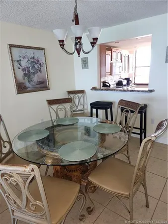a kitchen with granite countertop a sink stove and cabinets