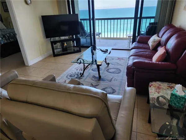 a living room with furniture and a flat screen tv