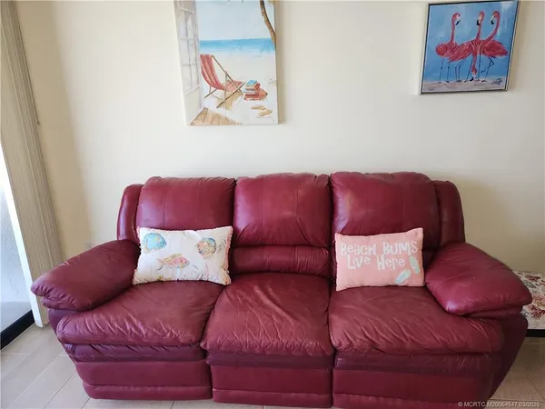 a dining room with kitchen island stainless steel appliances granite countertop a sink a stove and a dining table