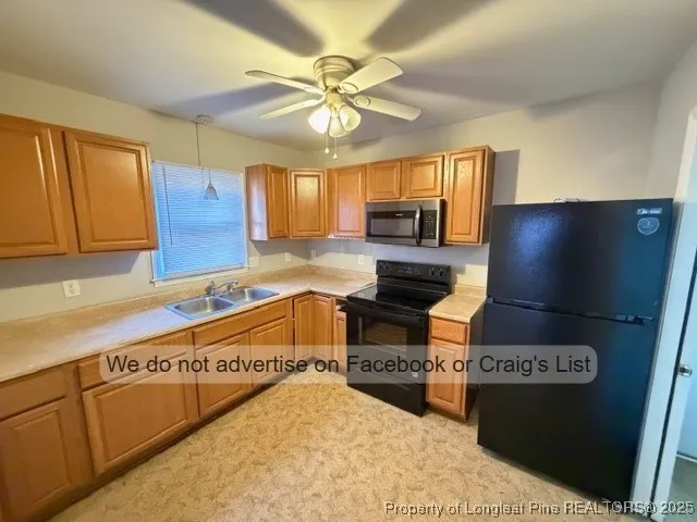 a kitchen with a sink appliances and cabinets